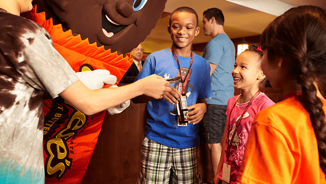 Kids interacting with Hersheypark characters.