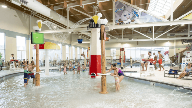 Families playing in the pool at the indoor water park.