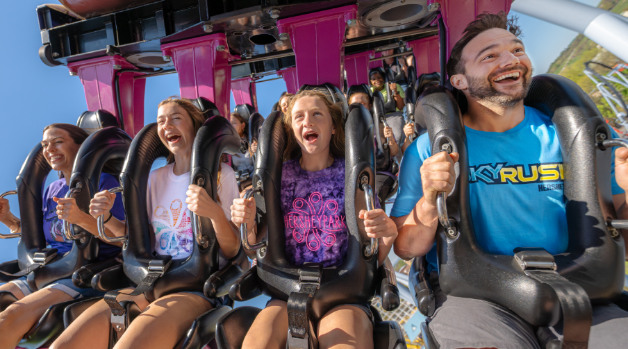 family riding rollercoaster together.