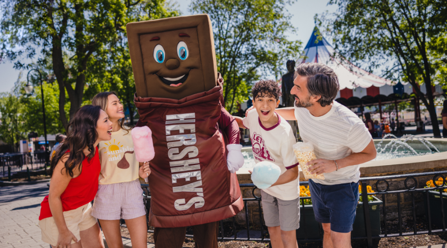 Family posed with Hershey, character.