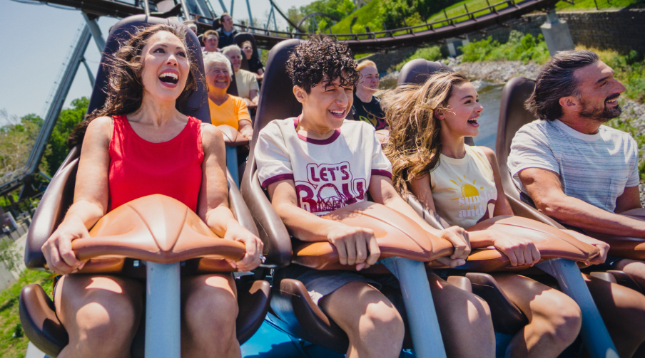 Family riding coaster together.