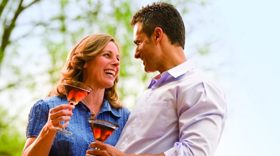 Man and woman holding wine outside of the Hershey Lodge