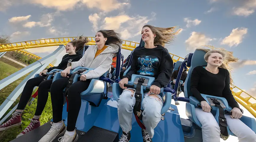 Group of people in Hersheypark sweatshirts riding Great Bear Coaster.